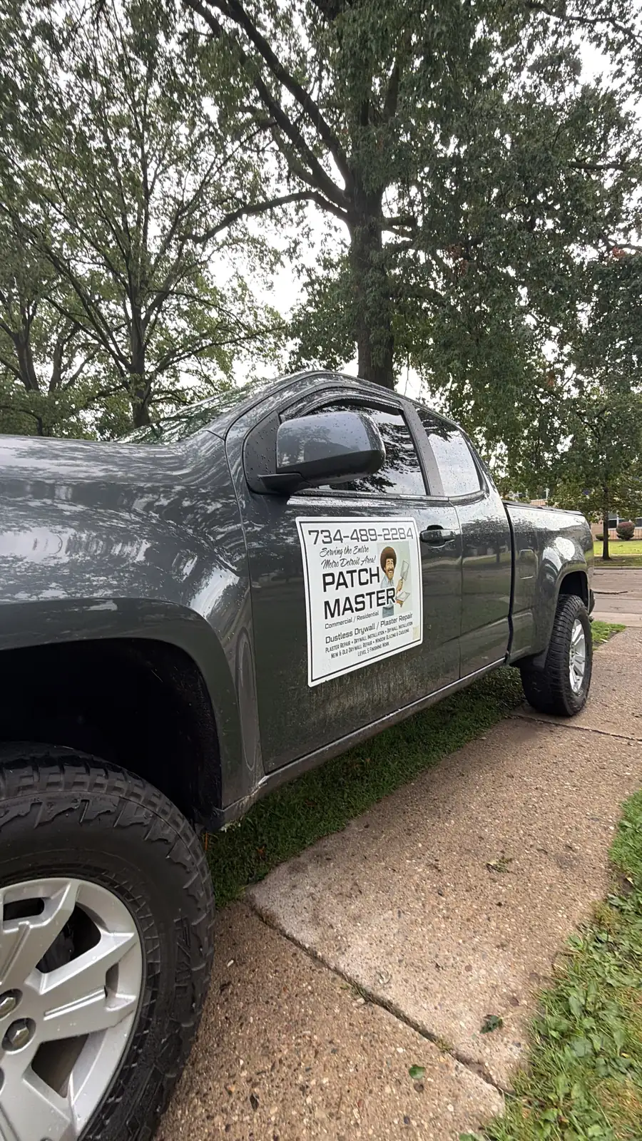 Patch Master work truck with the phone number 734-489-2284 on the door sign